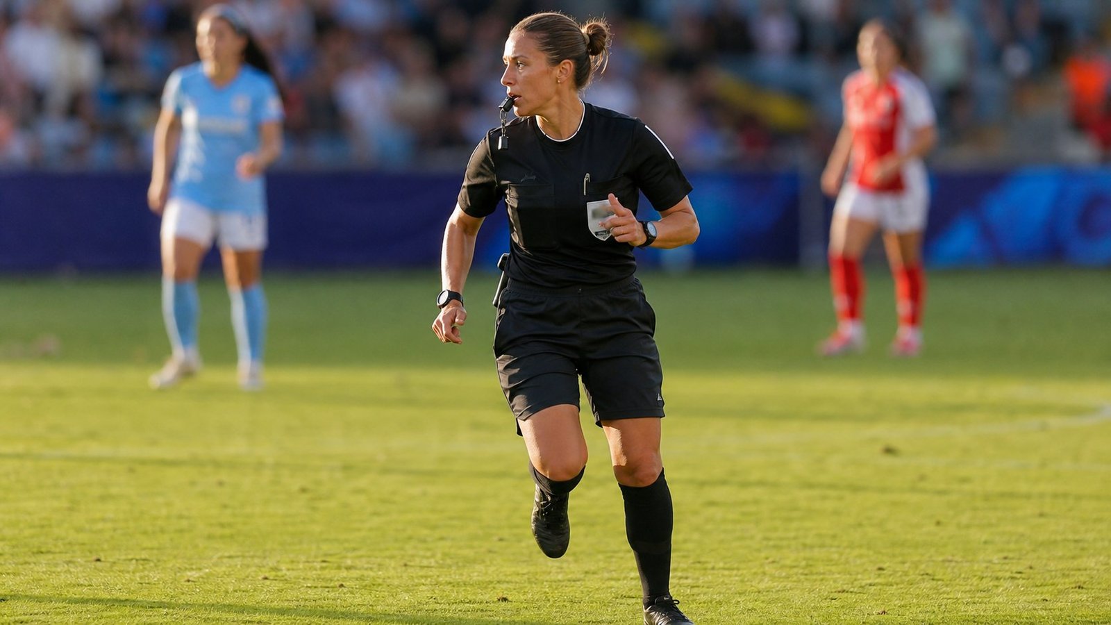 Female soccer referee moving with live play